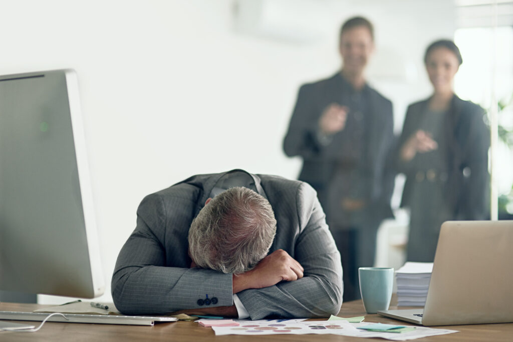 man sleeping at his desk