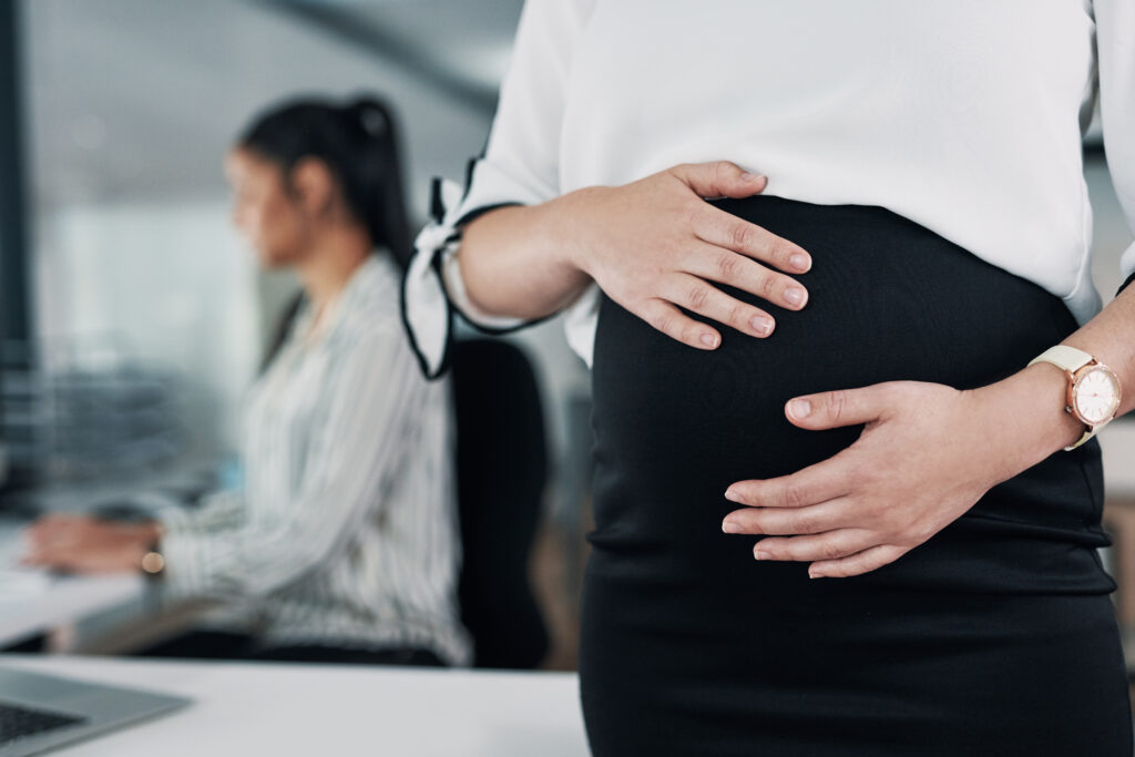 pregnant woman with hands on her bump