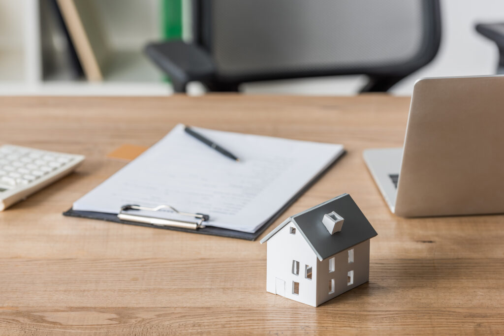 tiny house model and documents on a table